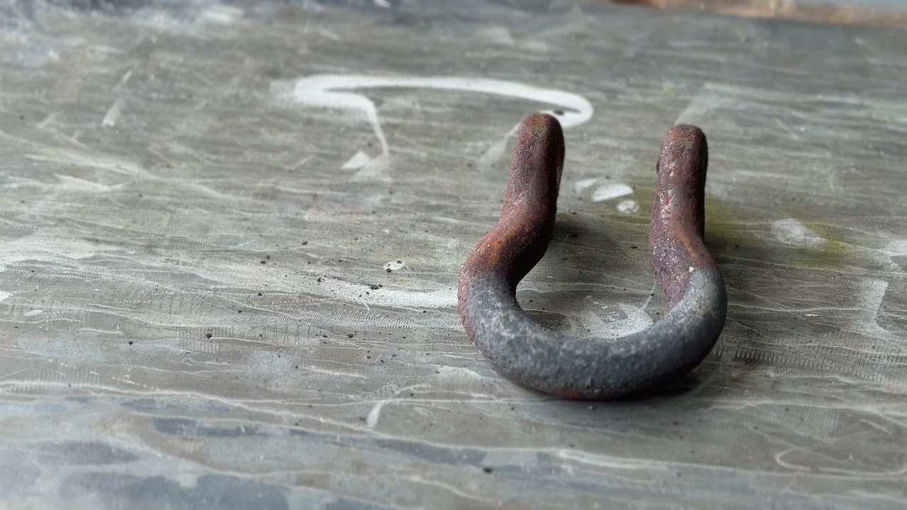 The same shackle partway through laser cleaning