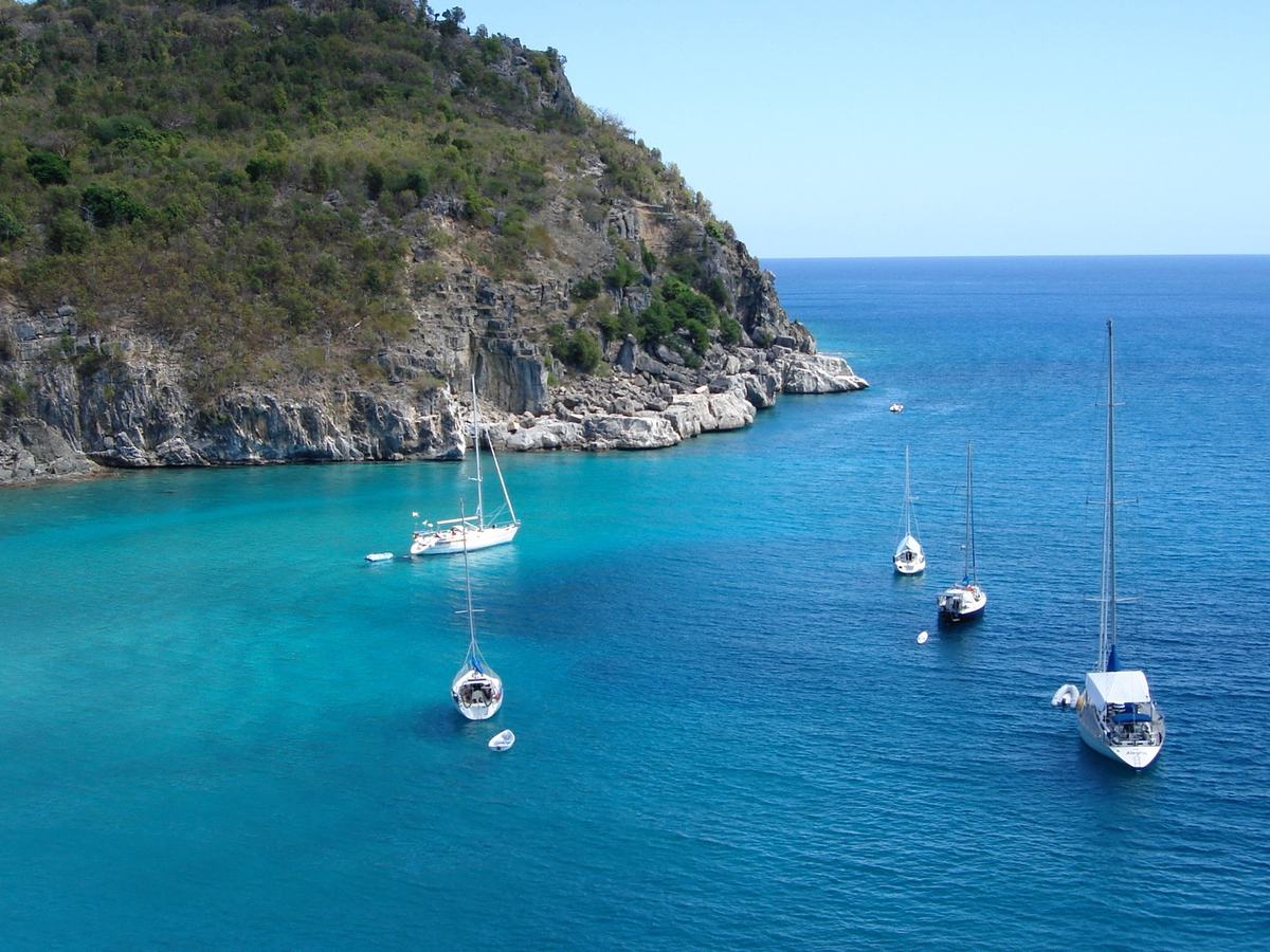 Sailboats anchored in a turquoise bay