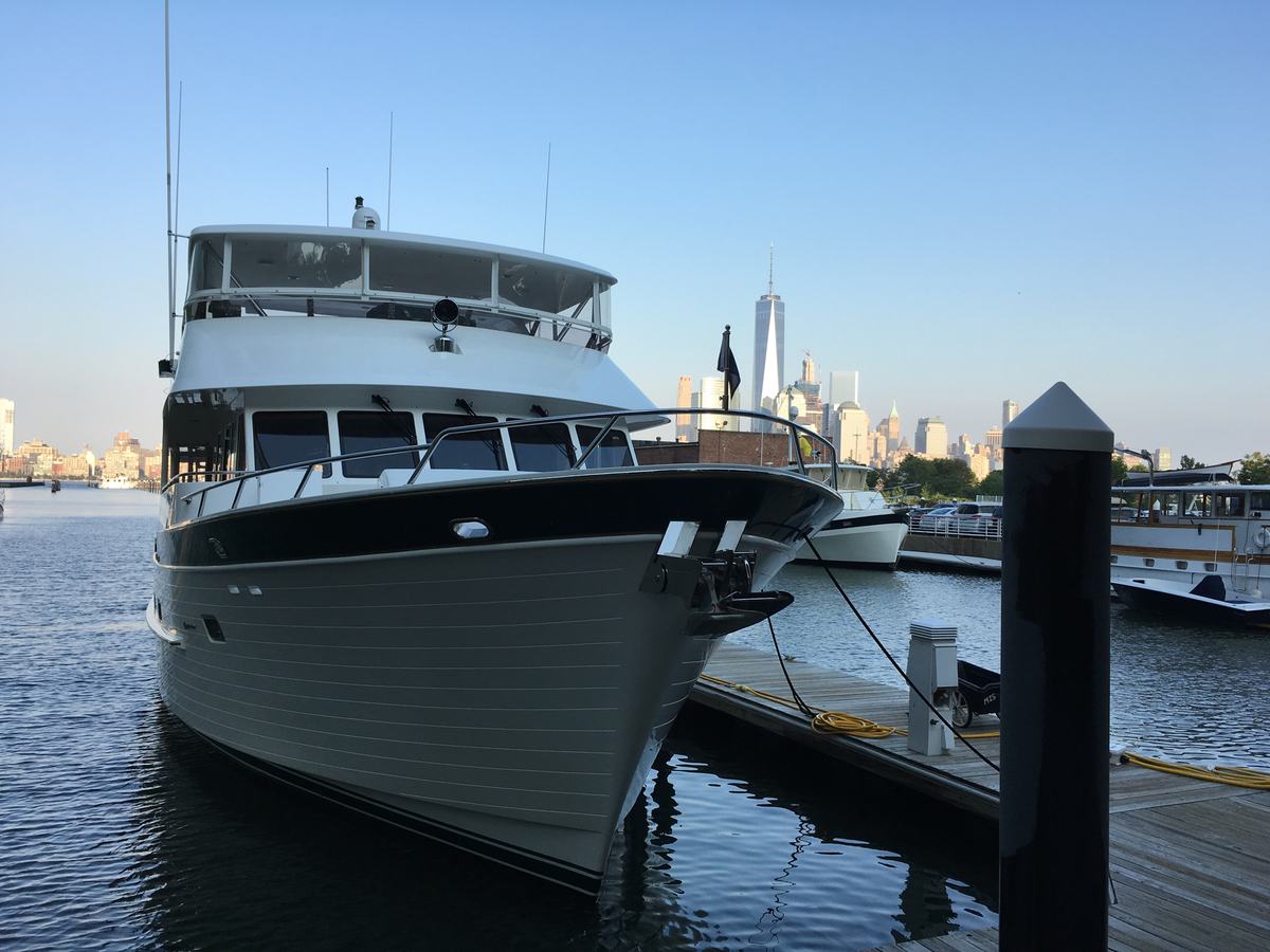 Motor yacht at a dock with a city skyline