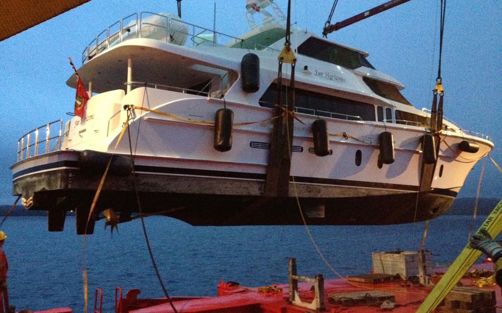 Yacht being lifted by crane for shipping